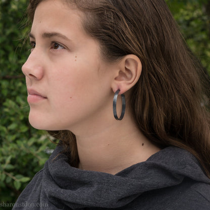 Solid 925 sterling silver hoop earrings handmade by Sharon SaintDon in the USA. 40mm diameter, 5mm wide, Matte shiny finish, hammered wavy texture, sterling silver posts and backs.