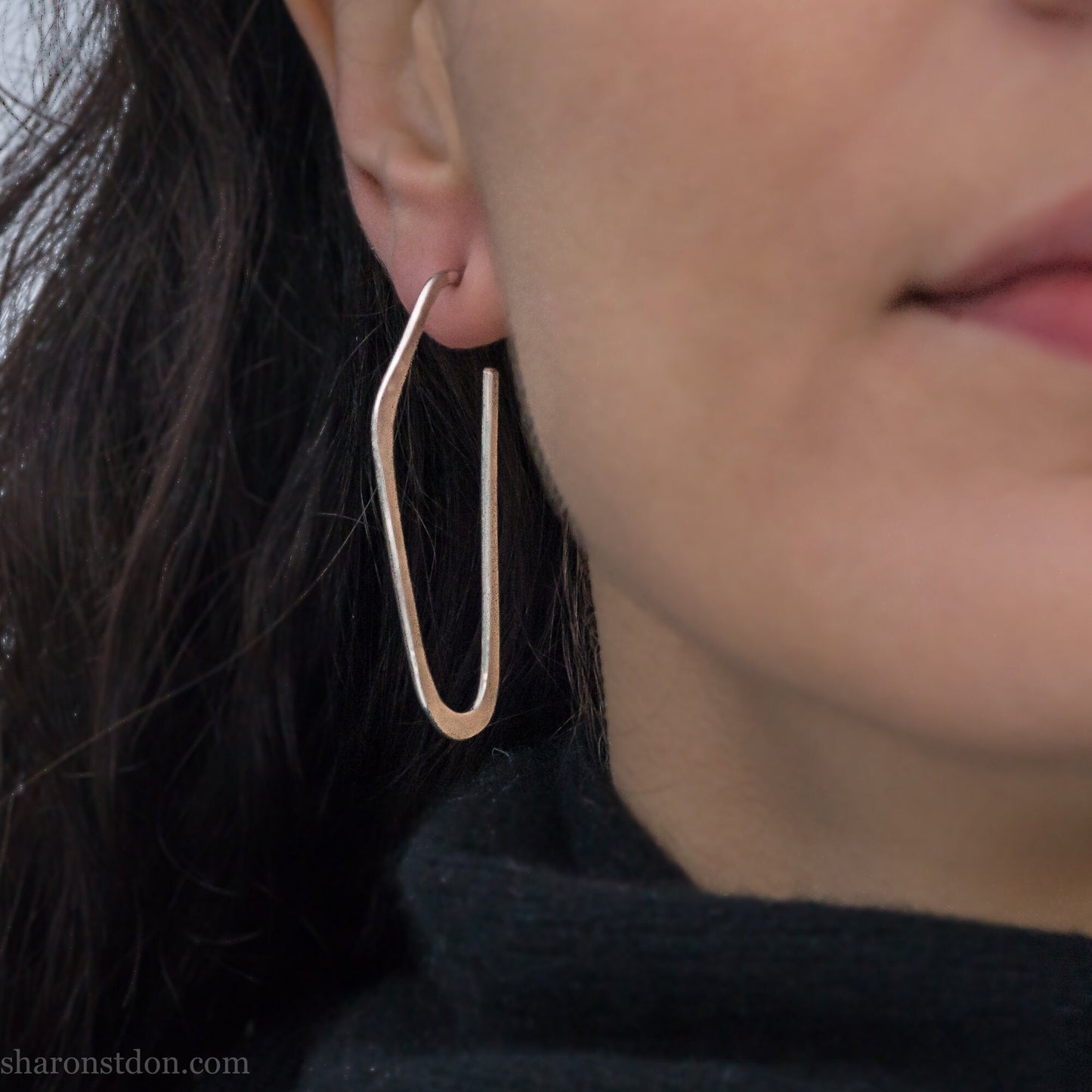 Solid 925 sterling silver hoop earrings, hammered, angular long high D shape. Matte finish, worn on ear.