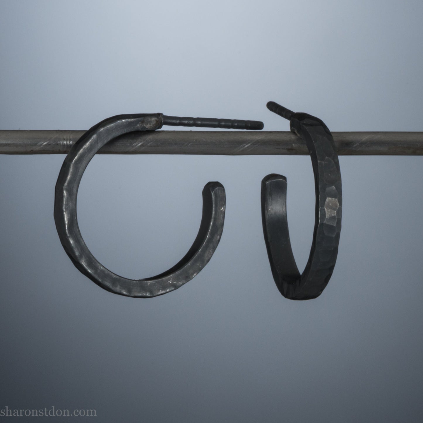 18x2mm oxidized black 925 sterling silver hammered hoop earrings, pair shown on display bar, matte dark patina.