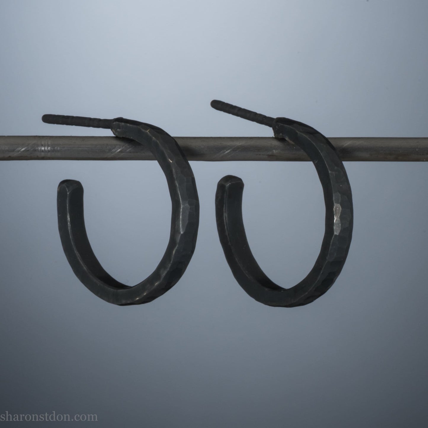 18x2mm oxidized black 925 sterling silver hammered hoop earrings, pair shown on display bar, matte dark patina