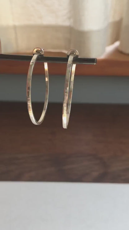 Solid 925 sterling silver hoop earrings. Handmade by Sharon SaintDon in North America. 40mm diameter, 2mm wide, 1.5mm thick, Brushed, matte finish and silver posts and backs.
