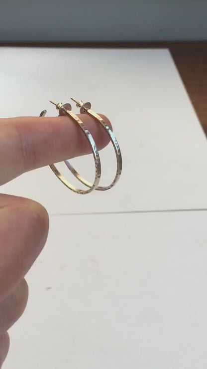 Handmade solid 925 sterling silver hoop earrings. 30mm diameter, 2mm wide, 1.5 thick. Silver posts and backs. Hammered by Sharon SaintDon in North America.