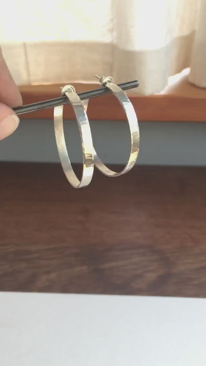 Solid 925 sterling silver hoop earrings handmade by Sharon SaintDon in the USA. 40mm diameter, 5mm wide, Matte shiny finish, hammered wavy texture, sterling silver posts and backs.