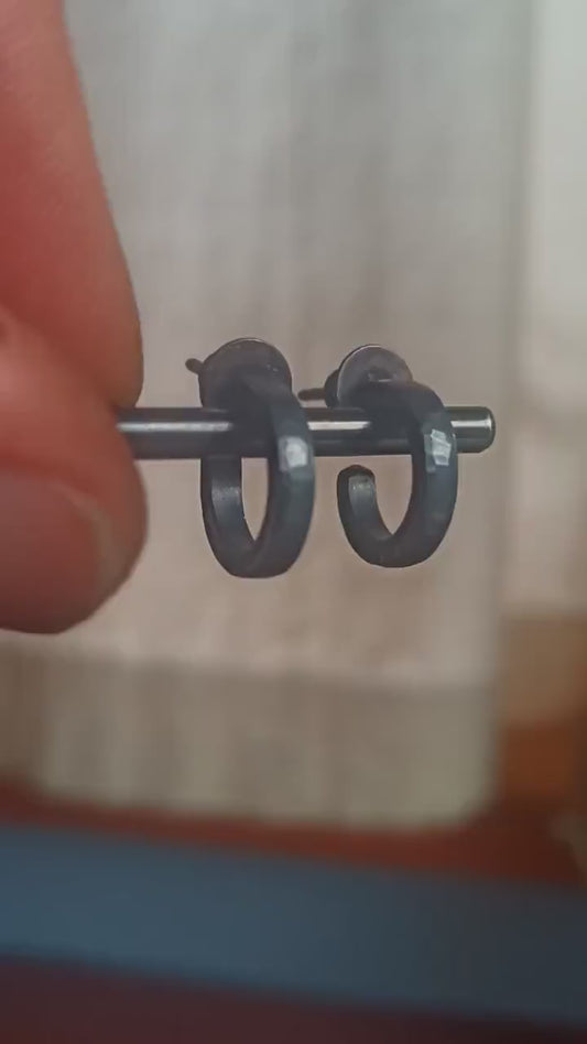 Solid 925 sterling silver hoop earrings for men with an oxidized matte black finish. 12mm exterior diameter, 9mm interior, 2mm wide, and 1.5mm thick. Solid sterling silver posts and backs. Handcrafted, each pair hand hammered by Sharon Saint Don in the Pacific Northwest of the USA.
