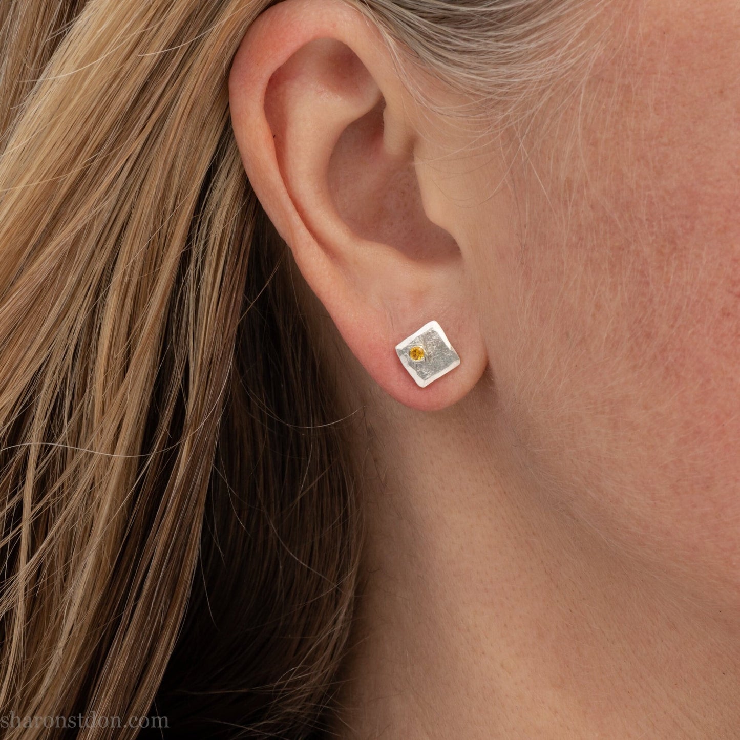 925 sterling silver square stud earrings with lab grown golden yellow topaz gemstones. 925 sterling silver handmade by Sharon SaintDon in North America. 7mm x 7mm, 1.5 thick with 2mm round flush set stone in corner. Silver posts and backs.