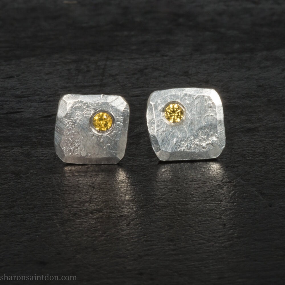 925 sterling silver square stud earrings with lab grown golden yellow topaz gemstones. 925 sterling silver handmade by Sharon SaintDon in North America. 7mm x 7mm, 1.5 thick with 2mm round flush set stone in corner. Silver posts and backs.