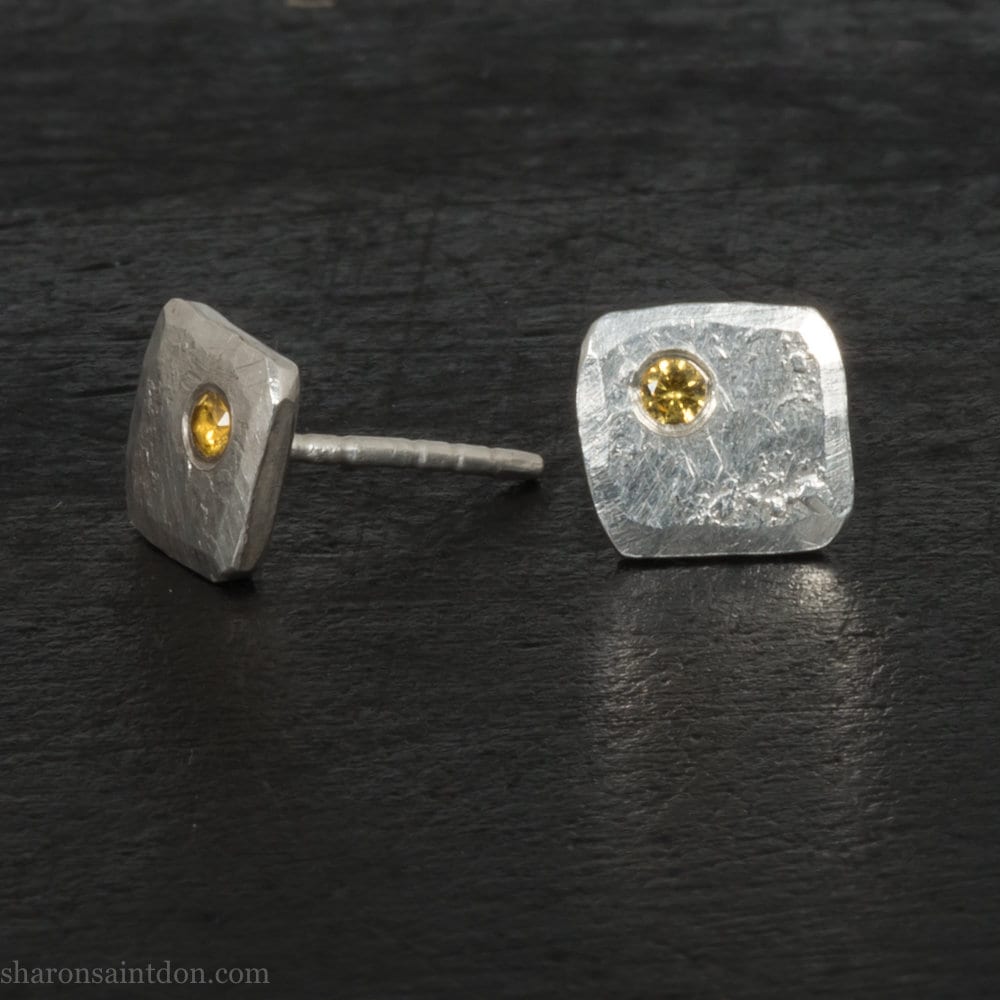 925 sterling silver square stud earrings with lab grown golden yellow topaz gemstones. 925 sterling silver handmade by Sharon SaintDon in North America. 7mm x 7mm, 1.5 thick with 2mm round flush set stone in corner. Silver posts and backs.