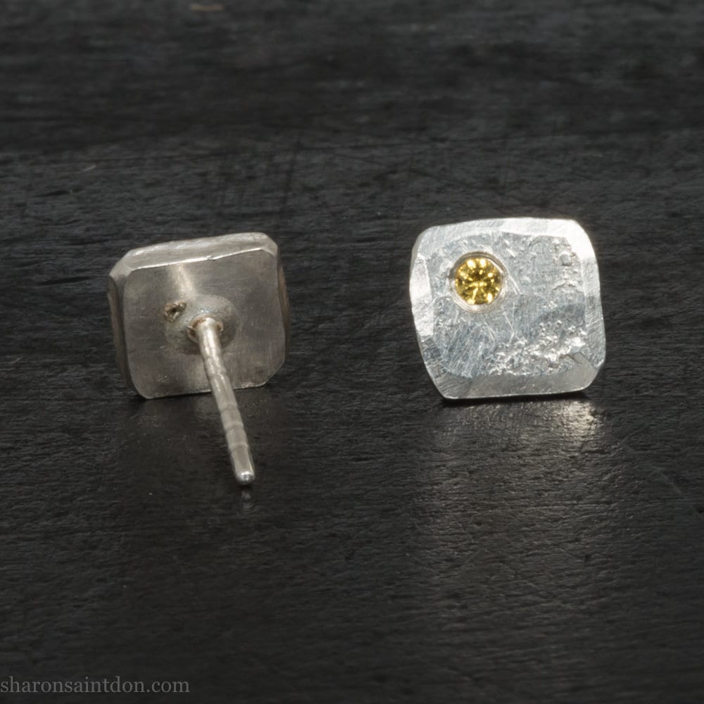 925 sterling silver square stud earrings with lab grown golden yellow topaz gemstones. 925 sterling silver handmade by Sharon SaintDon in North America. 7mm x 7mm, 1.5 thick with 2mm round flush set stone in corner. Silver posts and backs.