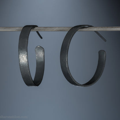 925 sterling silver hoop earrings. 30mm diameter round, 5mm wide, Handmade oxidized black by Sharon SaintDon. Solid Hammered silver with silver posts and backs.