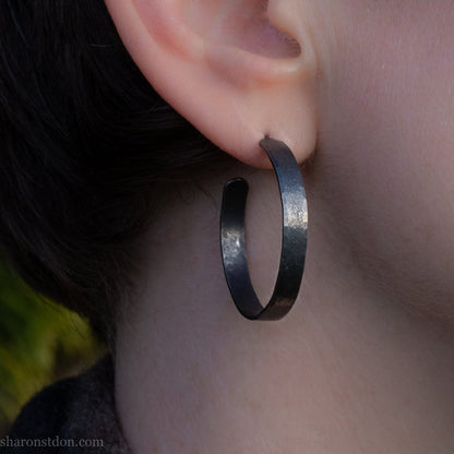 925 sterling silver hoop earrings. 30mm diameter round, 5mm wide, Handmade oxidized black by Sharon SaintDon. Solid Hammered silver with silver posts and backs.