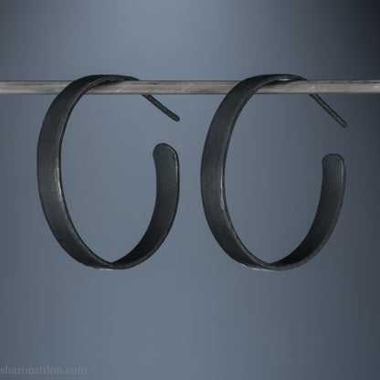 925 sterling silver hoop earrings. 30mm diameter round, 5mm wide, Handmade oxidized black by Sharon SaintDon. Solid Hammered silver with silver posts and backs.