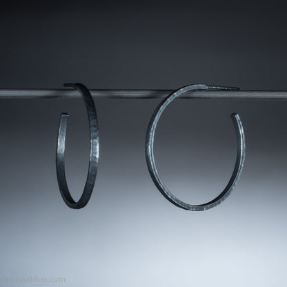 Oxidized black sterling silver hammered round hoop earrings. 30mm diameter, 2mm wide, solid hammered silver.