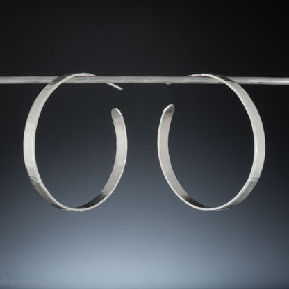 Solid 925 sterling silver hoop earrings handmade by Sharon SaintDon in the USA. 40mm diameter, 5mm wide, Matte shiny finish, hammered wavy texture, sterling silver posts and backs.