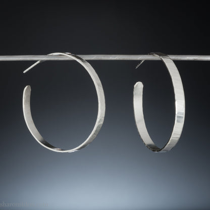 Solid 925 sterling silver hoop earrings handmade by Sharon SaintDon in the USA. 40mm diameter, 5mm wide, Matte shiny finish, hammered wavy texture, sterling silver posts and backs.