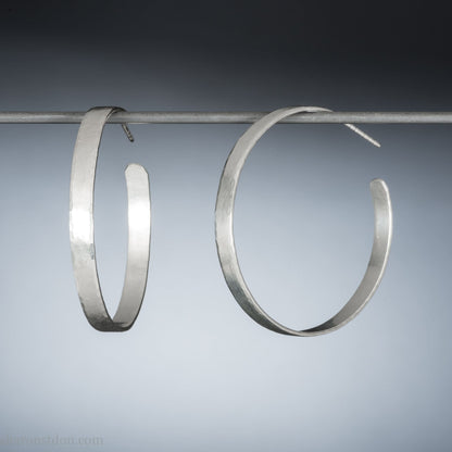 925 sterling silver hoop earrings handmade by Sharon SaintDon in the USA. 30mm diameter, 2mm wide, solid hammered silver. Oxidized black with sterling silver posts and backs.