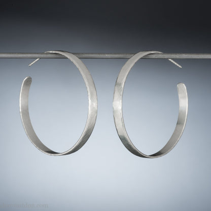 925 sterling silver hoop earrings handmade by Sharon SaintDon in the USA. 30mm diameter, 2mm wide, solid hammered silver. Oxidized black with sterling silver posts and backs.