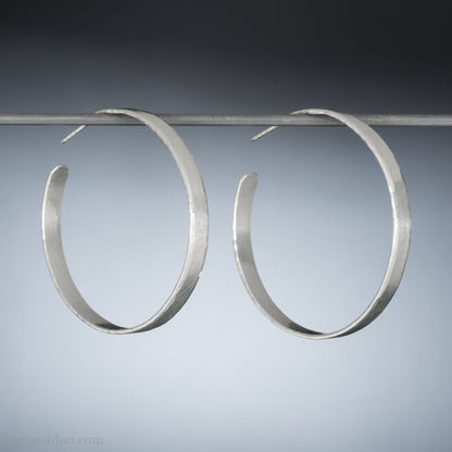 925 sterling silver hoop earrings handmade by Sharon SaintDon in the USA. 30mm diameter, 2mm wide, solid hammered silver. Oxidized black with sterling silver posts and backs.