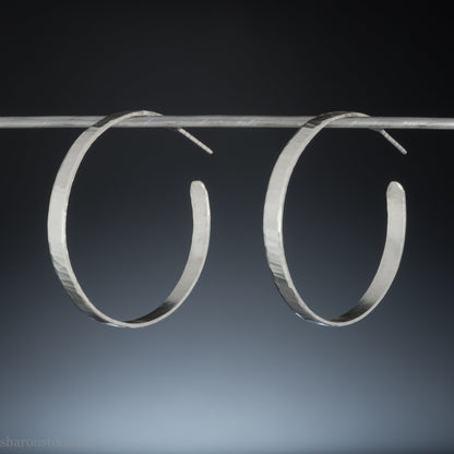 Solid 925 sterling silver hoop earrings handmade by Sharon SaintDon in the USA. 40mm diameter, 5mm wide, Matte shiny finish, hammered wavy texture, sterling silver posts and backs.