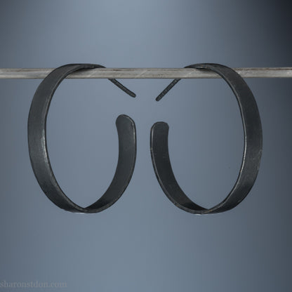 925 sterling silver hoop earrings. 30mm diameter round, 5mm wide, Handmade oxidized black by Sharon SaintDon. Solid Hammered silver with silver posts and backs.