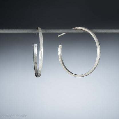 Handmade solid 925 sterling silver hoop earrings. 30mm diameter, 2mm wide, 1.5 thick. Silver posts and backs. Hammered by Sharon SaintDon in North America.