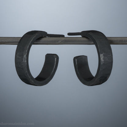 Black 925 sterling silver hoop earrings for men or women, non binary. 16mm x 4mm, thick, hammered solid silver. Handmade in the USA by Sharon SaintDon.