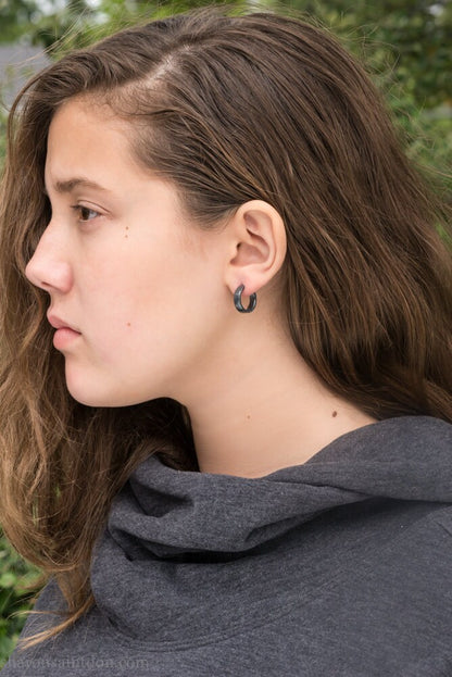 Black 925 sterling silver hoop earrings for men or women, non binary. 16mm x 4mm, thick, hammered solid silver. Handmade in the USA by Sharon SaintDon.