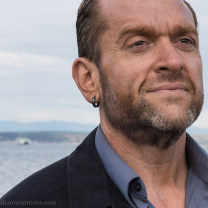 Black 925 sterling silver hoop earrings for men or women, non binary. 16mm x 4mm, thick, hammered solid silver. Handmade in the USA by Sharon SaintDon.