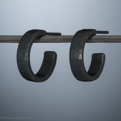 Black 925 sterling silver hoop earrings for men or women, non binary. 16mm x 4mm, thick, hammered solid silver. Handmade in the USA by Sharon SaintDon.