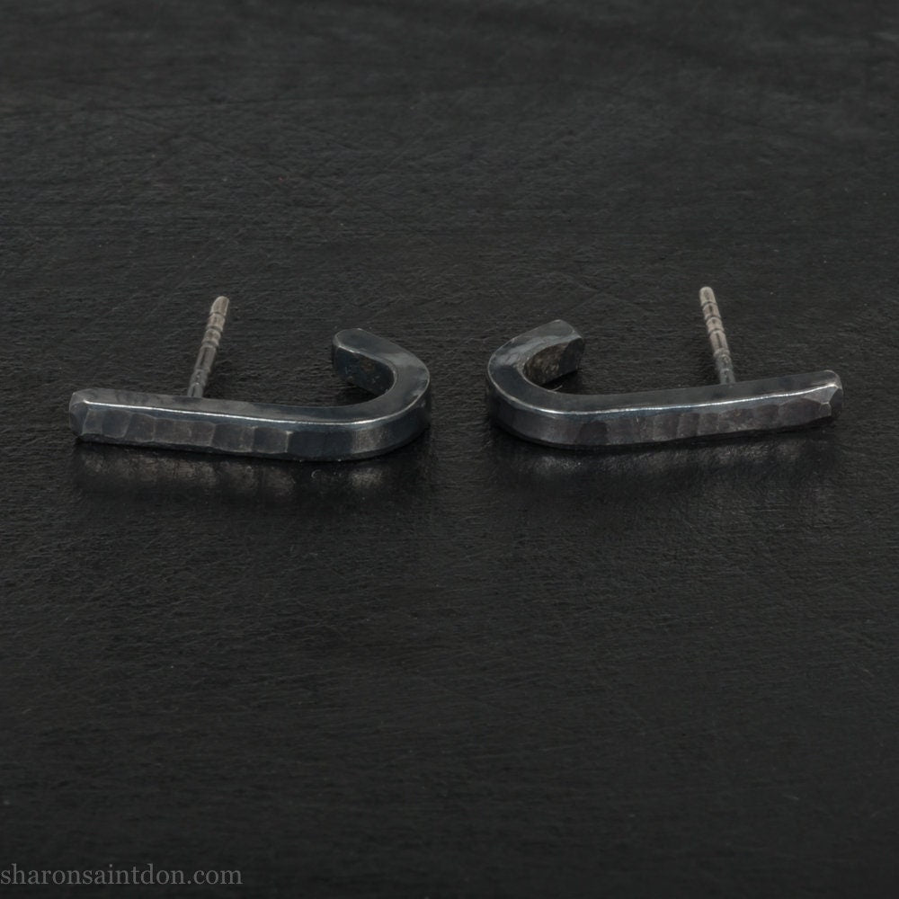 Small Handmade 925 sterling silver huggie wrap stud earrings. Minimalist, oxidized black, for men or women made by Sharon SaintDon in North America. SIZE: 17mm high x 2mm wide- the space from the post to bottom of the ear lobe is about 9mm.