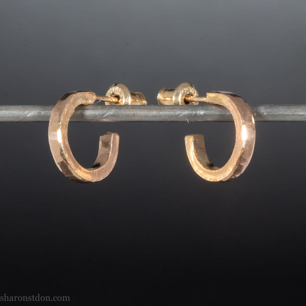 Solid 18k yellow gold hoop earrings set, handmade in North America by Sharon SaintDon.12mm diameter round, 2mm wide, 1.5mm thick, with hammered texture and matte finish.