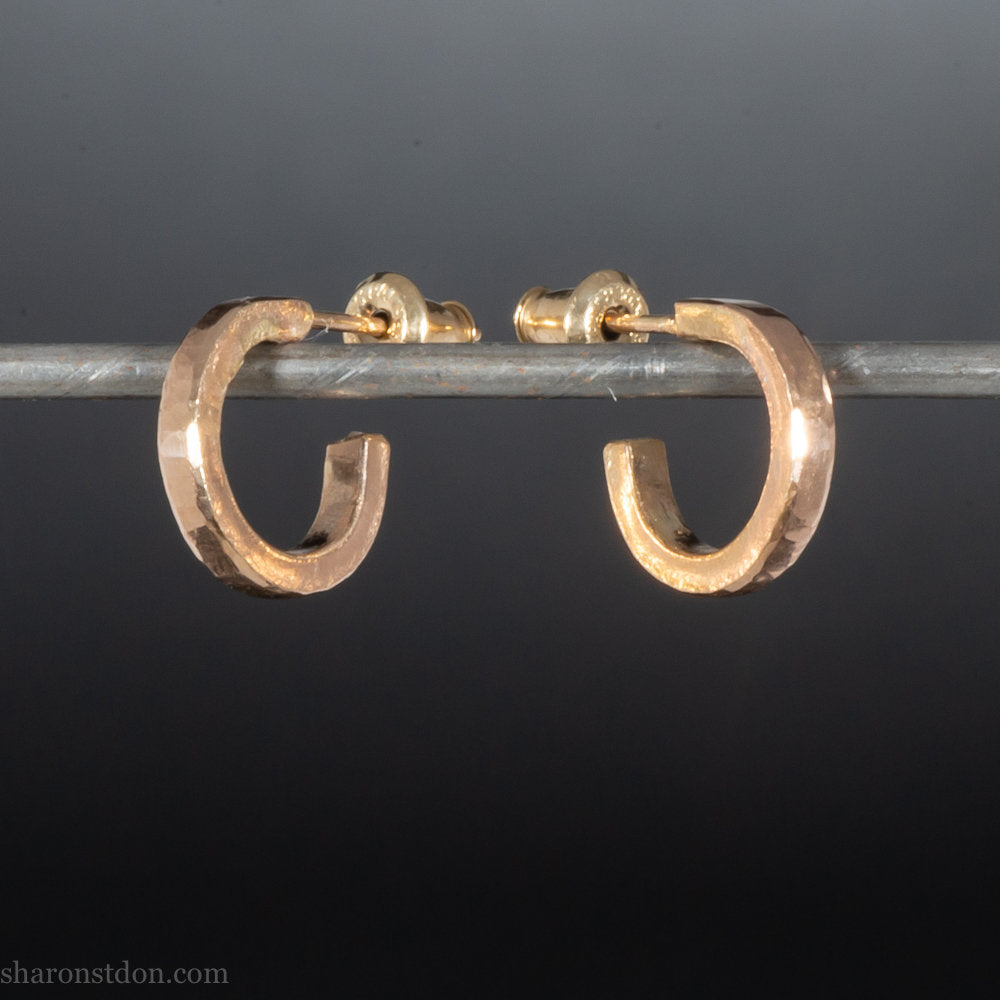 12mm x 2mm solid 18k gold hoop earrings for men. Exterior diameter 12mm, Interior diameter 9mm. Handmade by Sharon SaintDon in North America. Hammered, solid, real gold with gold posts.