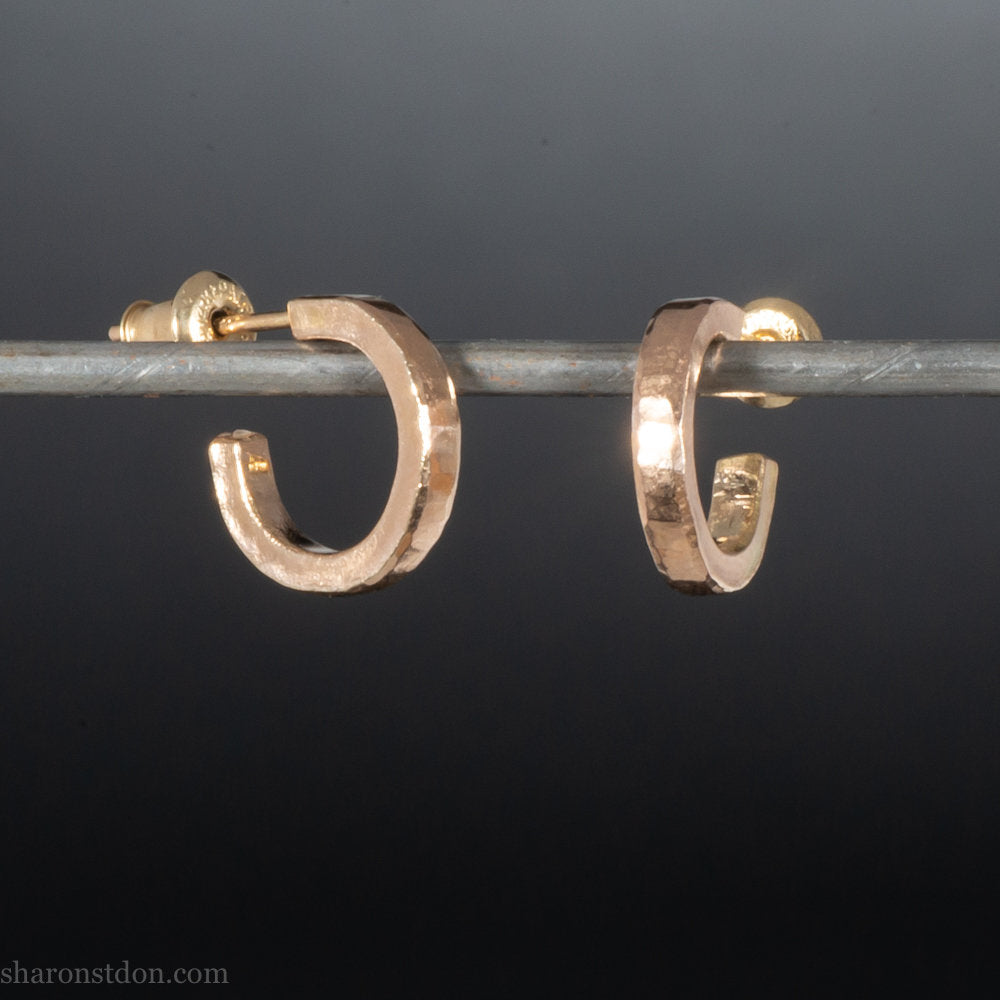 12mm x 2mm solid 18k gold hoop earrings for men. Exterior diameter 12mm, Interior diameter 9mm. Handmade by Sharon SaintDon in North America. Hammered, solid, real gold with gold posts.