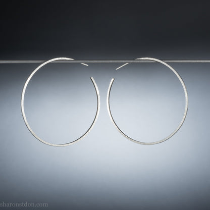 handmade 925 sterling silver hoop earrings for women. Comfortable, lightweight, daily wear earrings with a hammered, wavy texture.