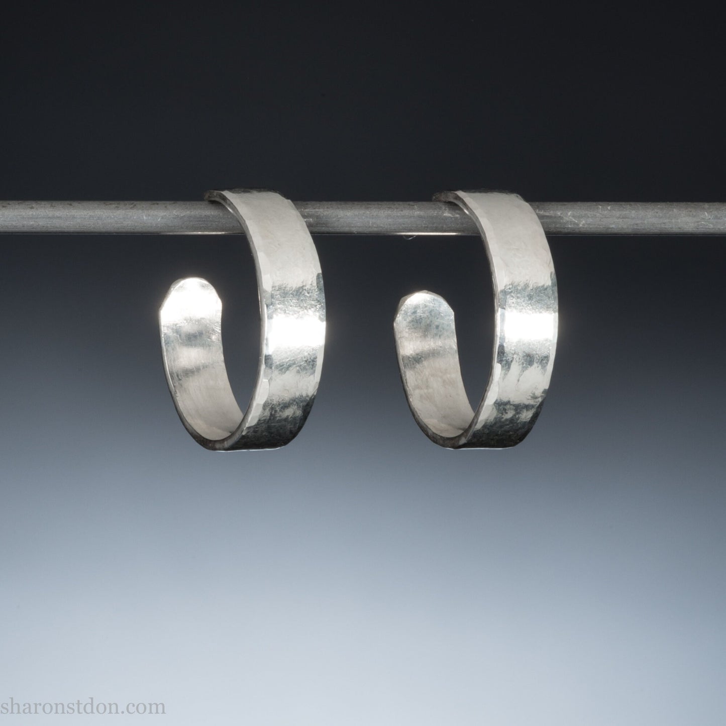 925 sterling silver hoop earrings handmade in North America by Sharon SaintDon. Small, shiny, 18mm diameter, 5mm Wide, shiny, round with hammered texture.