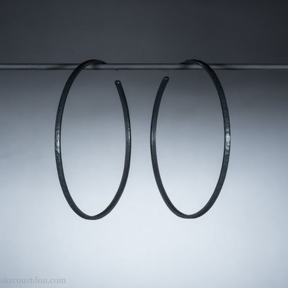 Handmade 925 sterling silver hoop earrings for women. 55mm diameter, 2mm wide, oxidized black, large hoops for daily wear. Minimalist, comfortable, lightweight with a hammered, texture.