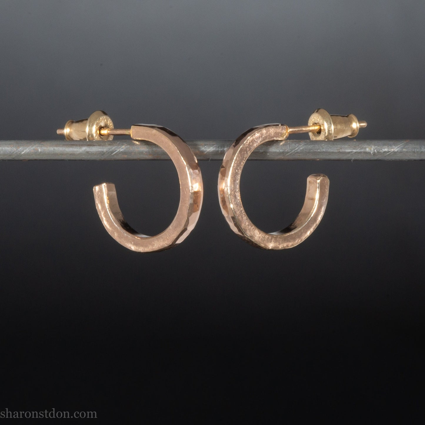 Gold hoop earrings set handmade in North America by Sharon SaintDon. Solid 14k yellow gold, 14mm diameter round with hammered texture.