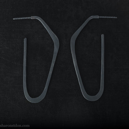 925 sterling silver hoop earrings handmade in North America by Sharon SaintDon. Long, angular, high D shape, oxidized black with hammered texture. SIZE: 47mm high x 19mm wide