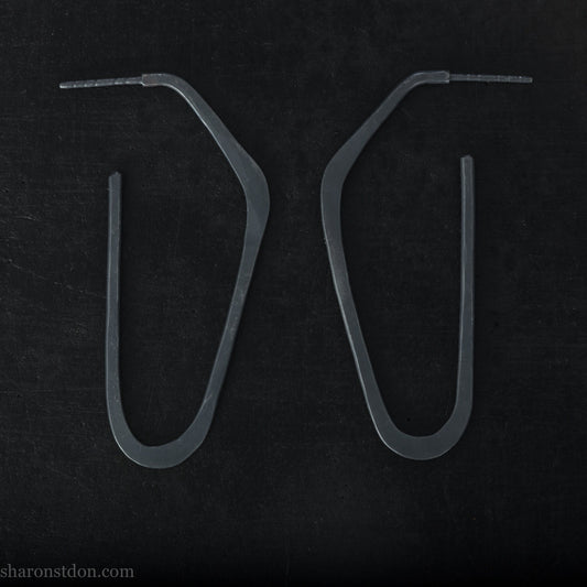 925 sterling silver hoop earrings handmade in North America by Sharon SaintDon. Long, angular, high D shape, oxidized black with hammered texture. SIZE: 47mm high x 19mm wide