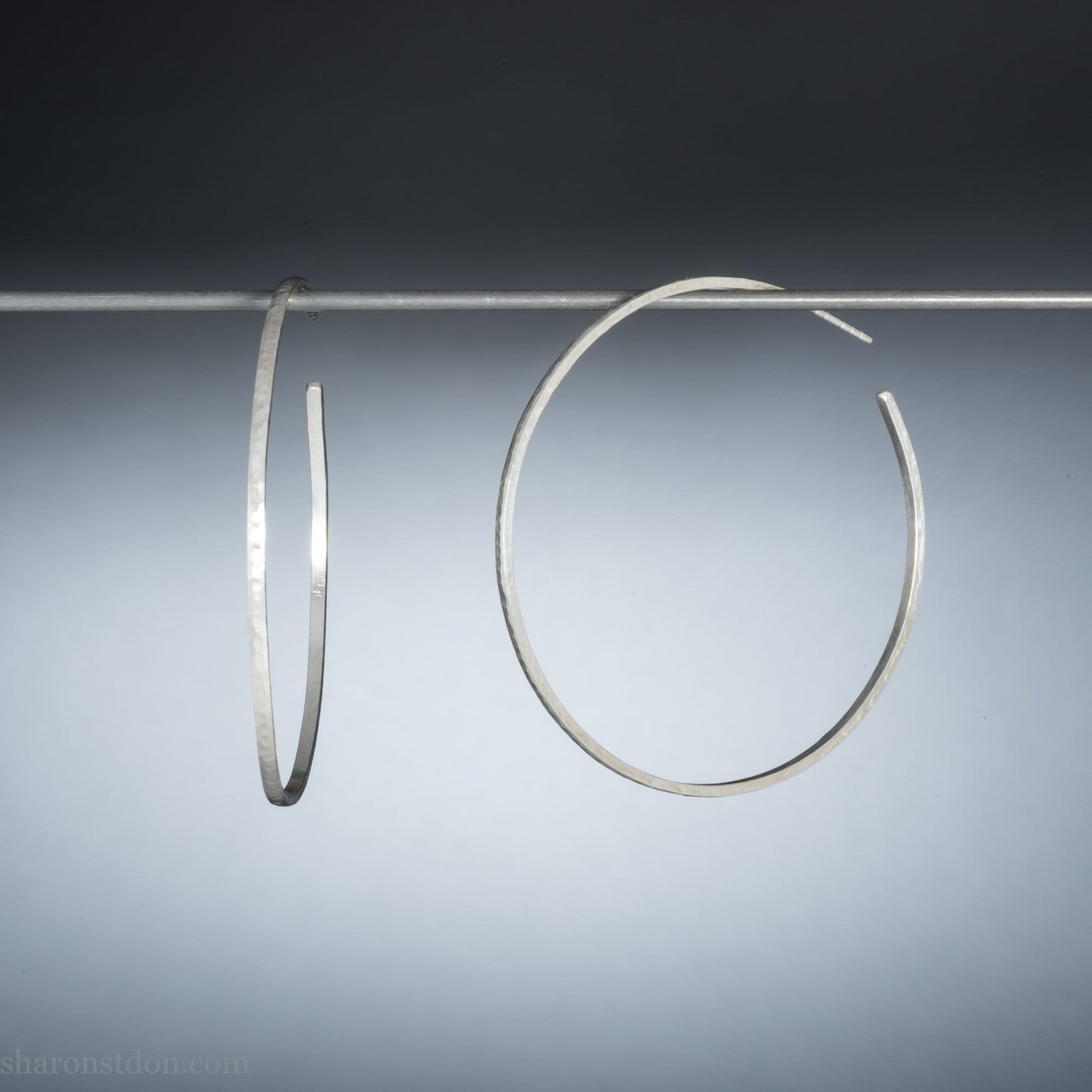 handmade 925 sterling silver hoop earrings for women. Comfortable, lightweight, daily wear earrings with a hammered, wavy texture.