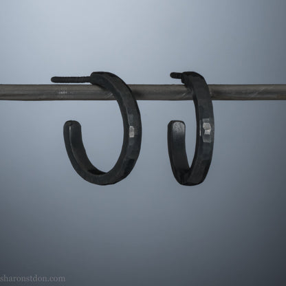 16mm x 2mm 925 sterling silver hoop earrings for men, handmade in North America by Sharon SaintDon. Oxidized black silver, small, round with hammered texture.