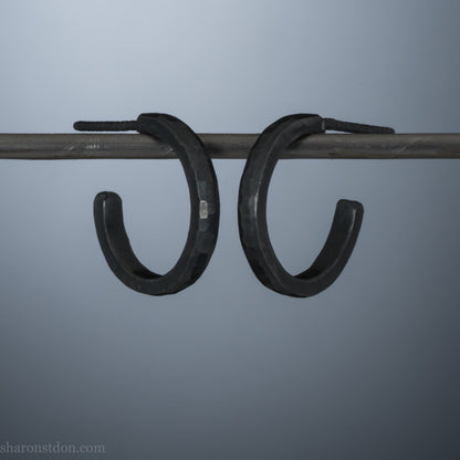 16mm x 2mm 925 sterling silver hoop earrings for men, handmade in North America by Sharon SaintDon. Oxidized black silver, small, round with hammered texture.