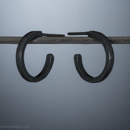 16mm x 2mm 925 sterling silver hoop earrings for men, handmade in North America by Sharon SaintDon. Oxidized black silver, small, round with hammered texture.