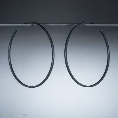 Handmade 925 sterling silver hoop earrings for women. 55mm diameter, 2mm wide, oxidized black, large hoops for daily wear. Minimalist, comfortable, lightweight with a hammered, texture.