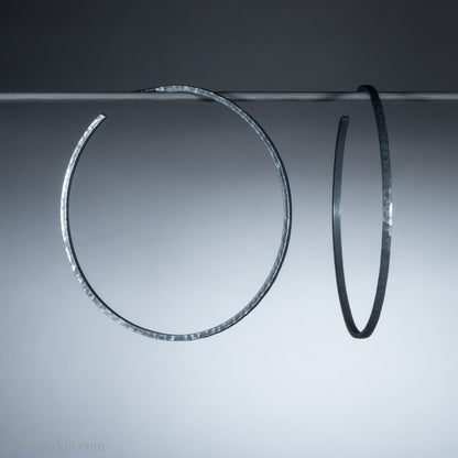 Handmade 925 sterling silver hoop earrings for women. 55mm diameter, 2mm wide, oxidized black, large hoops for daily wear. Minimalist, comfortable, lightweight with a hammered, texture.