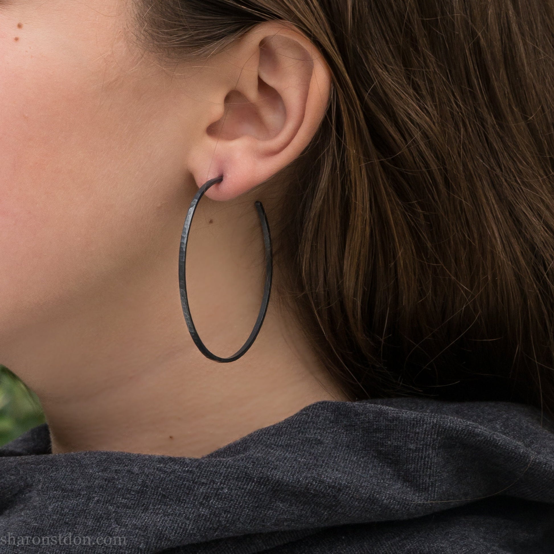 Handmade 925 sterling silver hoop earrings for women. 55mm diameter, 2mm wide, oxidized black, large hoops for daily wear. Minimalist, comfortable, lightweight with a hammered, texture.