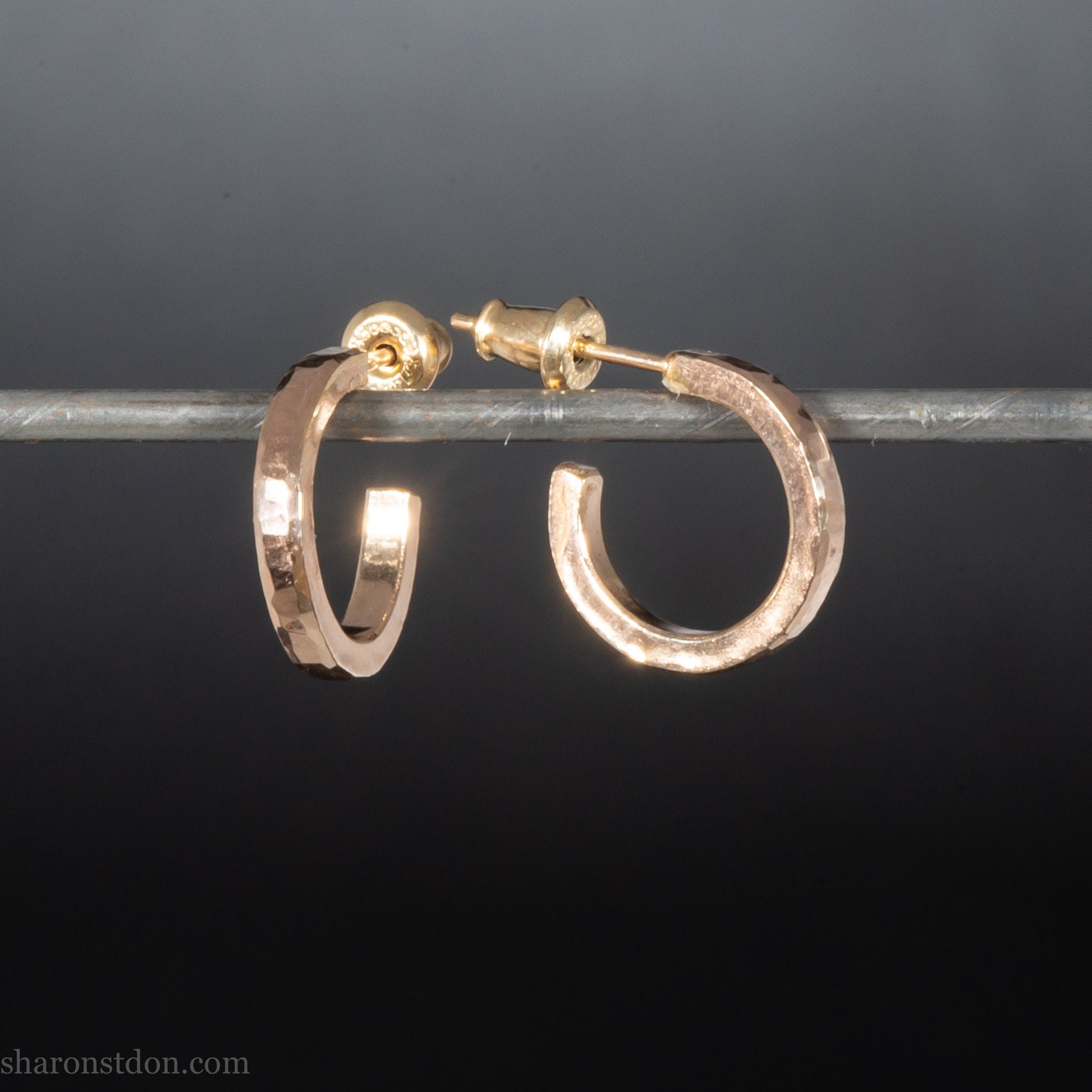 Gold hoop earrings set handmade in North America by Sharon SaintDon. Solid 14k yellow gold, 14mm diameter round with hammered texture.