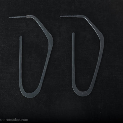 925 sterling silver hoop earrings handmade in North America by Sharon SaintDon. Long, angular, high D shape, oxidized black with hammered texture. SIZE: 47mm high x 19mm wide