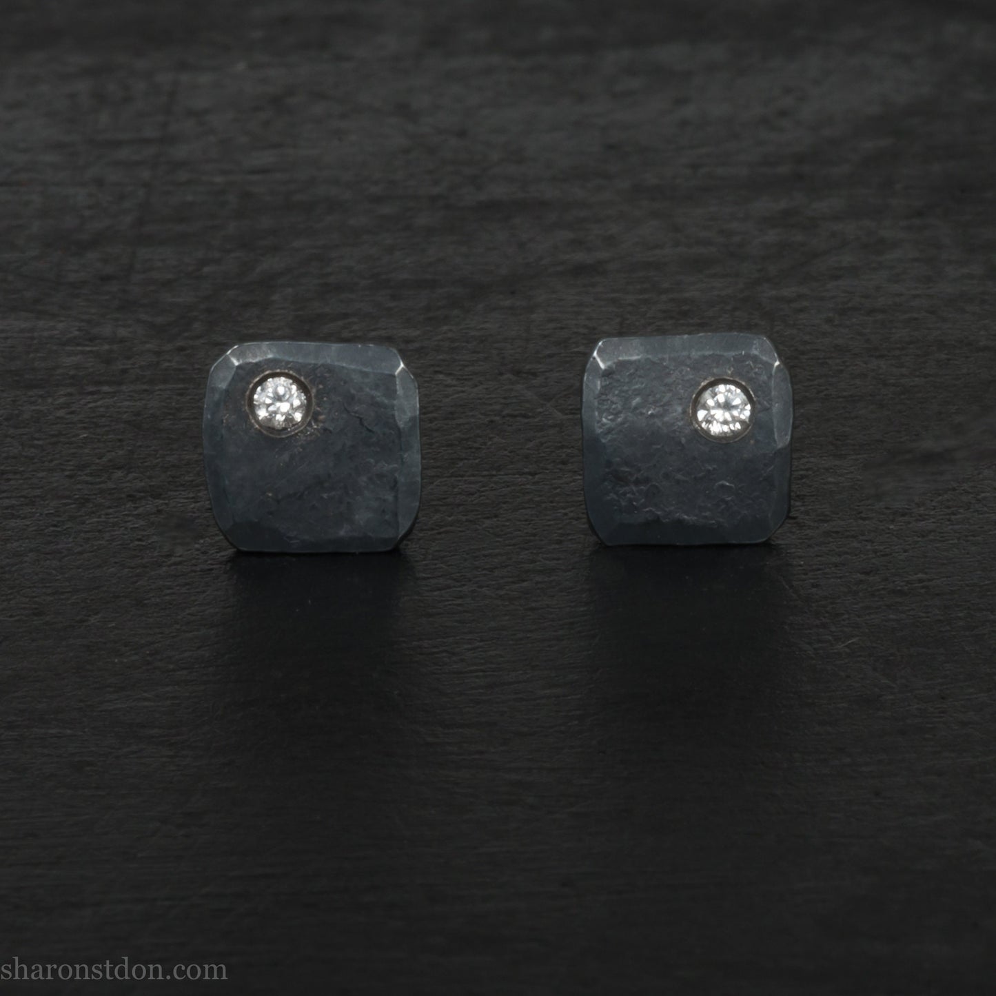 Handmade oxidized black 925 sterling silver stud earrings with cubic zirconia gemstone in the corner. Small 7mm x 7mm square stud earrings made by Sharon SaintDon in North America.