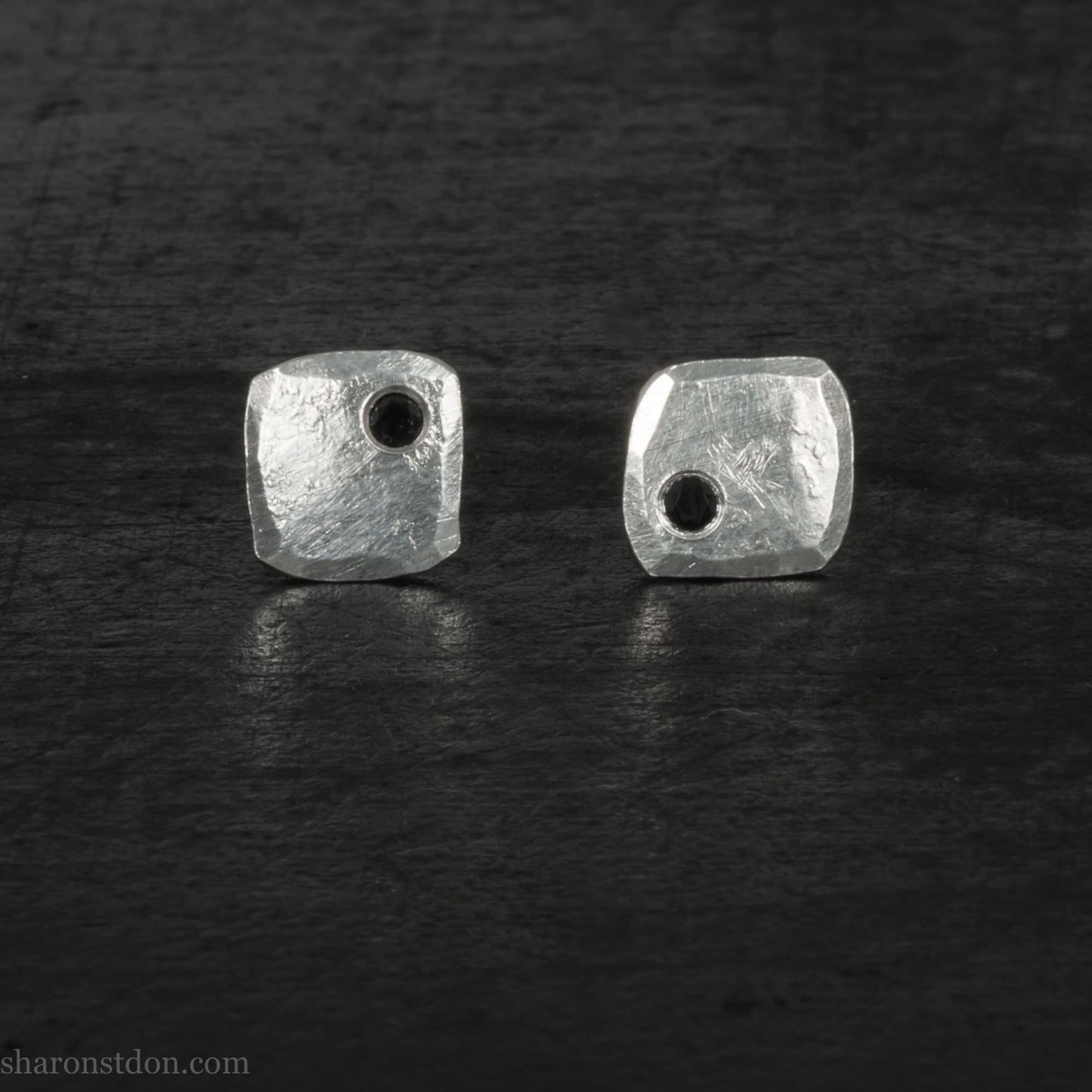 7mm x 7mm Handmade 925 sterling silver stud earrings with black spinel gemstone in the corner. Shiny, small square stud earrings made by Sharon SaintDon in North America.