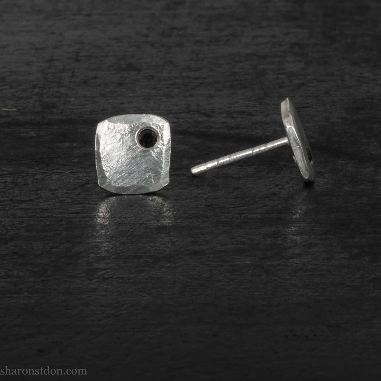 7mm x 7mm Handmade 925 sterling silver stud earrings with black spinel gemstone in the corner. Shiny, small square stud earrings made by Sharon SaintDon in North America.
